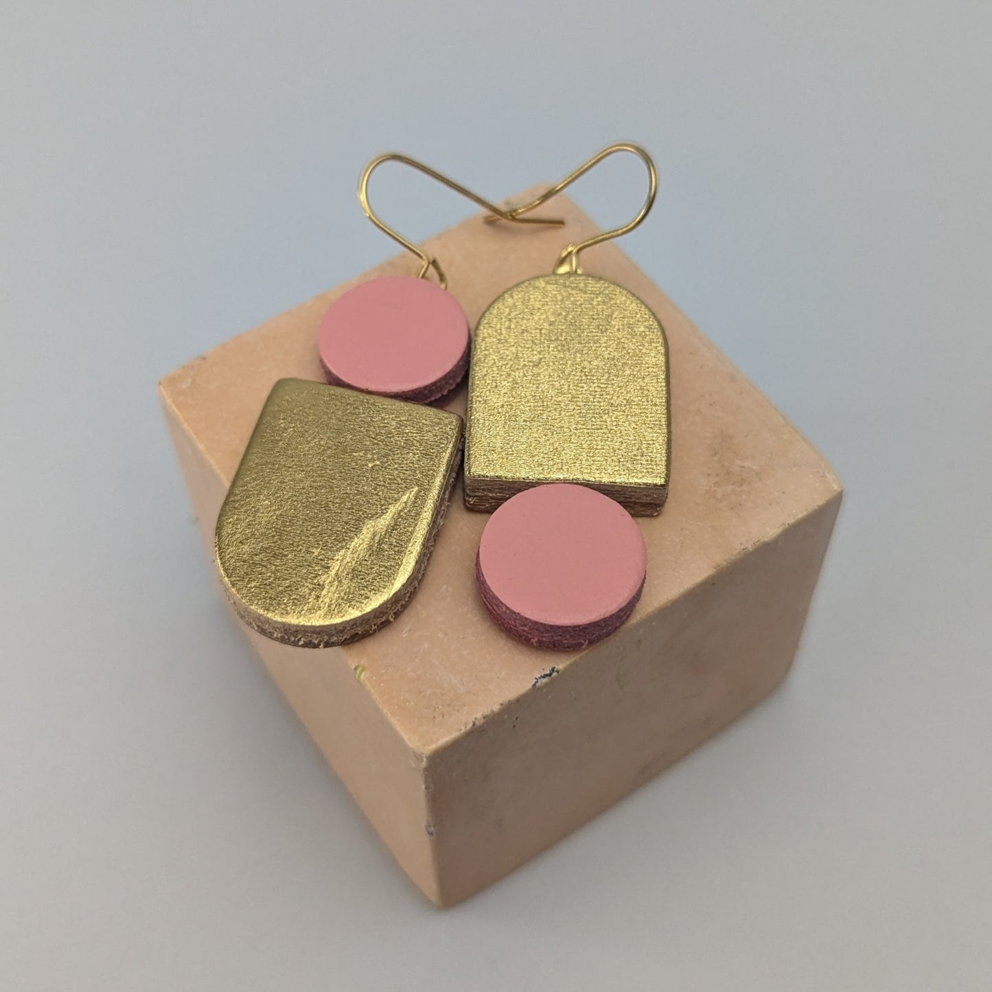 Leather totem earring in gold and Pale pink by Kay Morgan, Bristol.