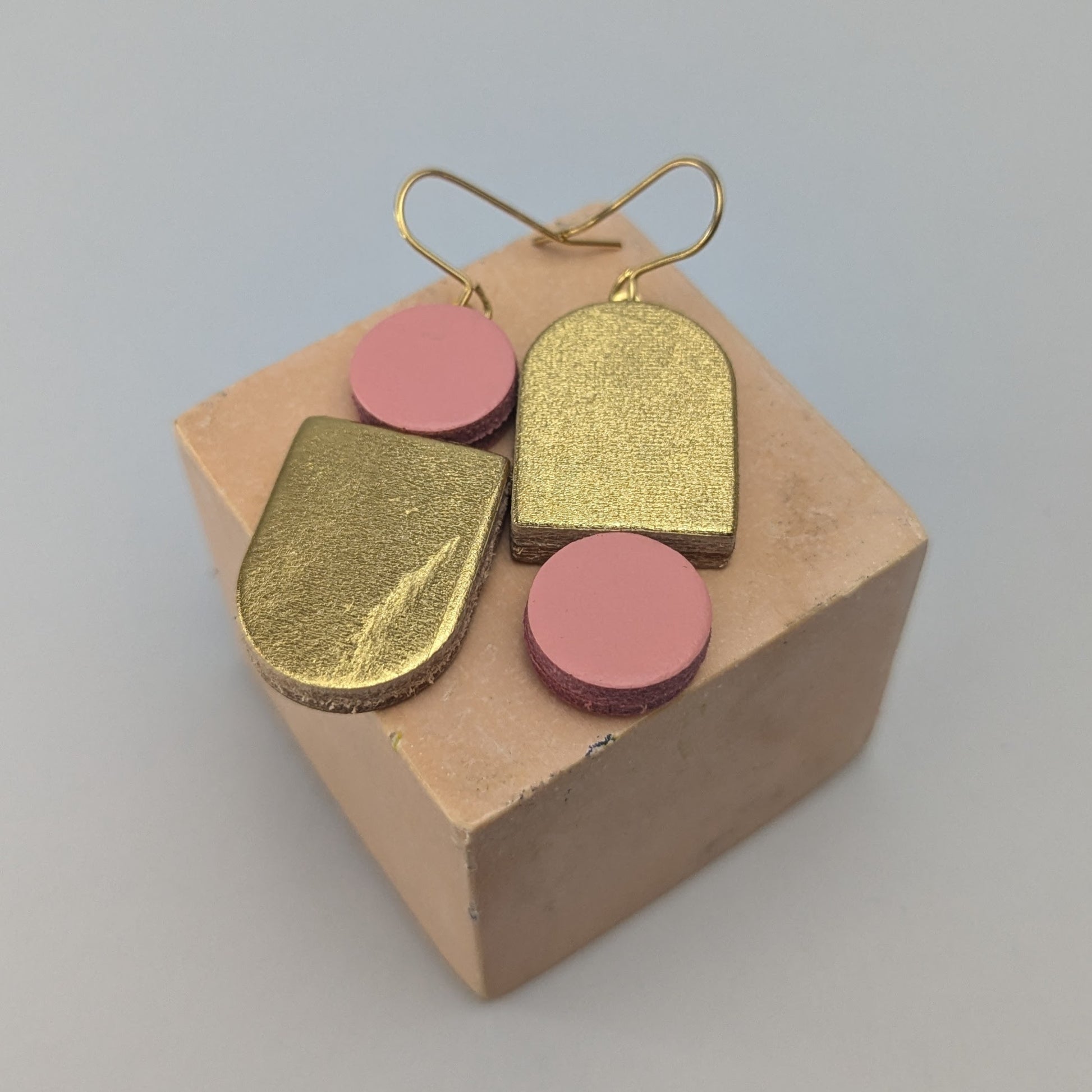Leather totem earring in gold and Pale pink by Kay Morgan, Bristol.