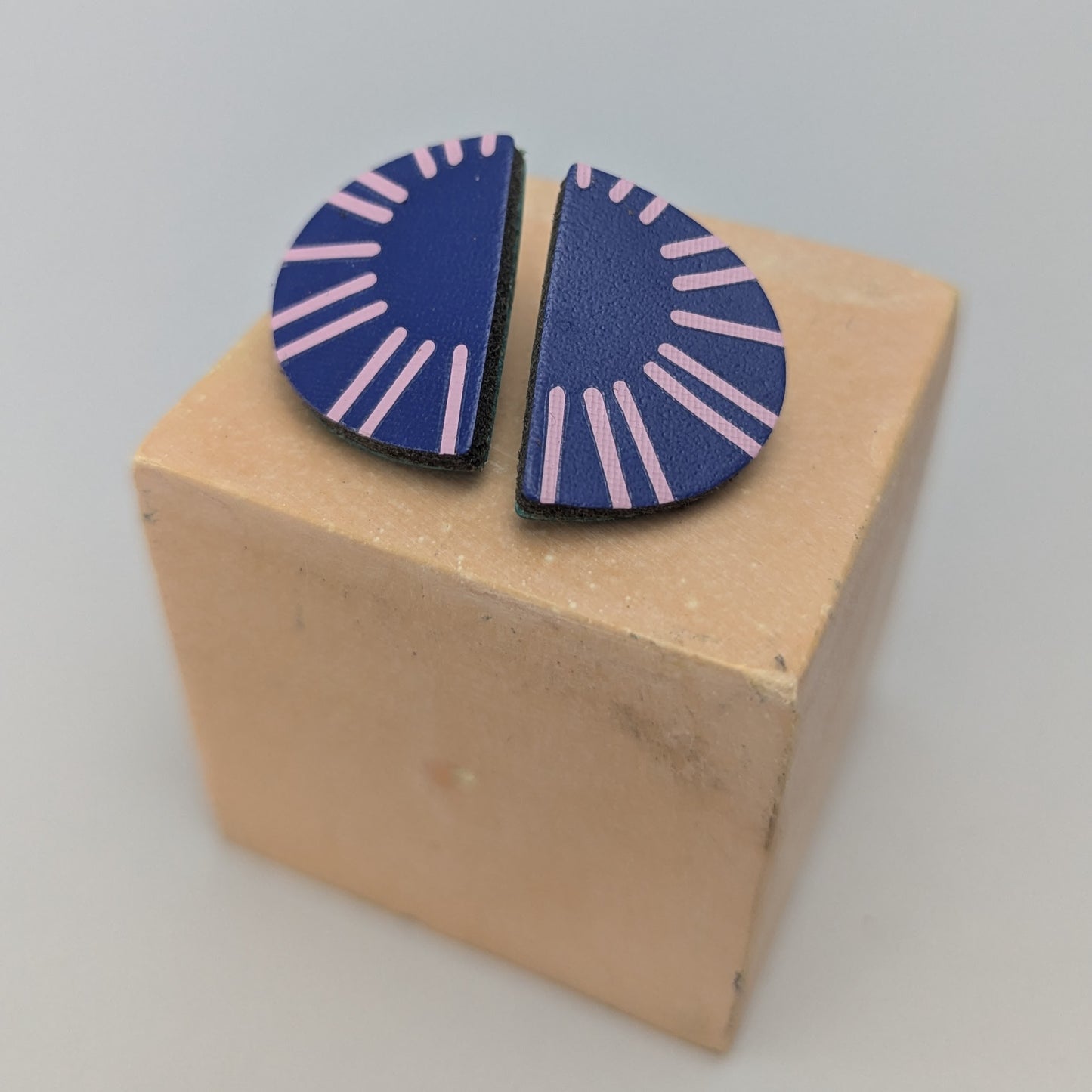 PATTERNED SEMI CIRCLE STUDS.