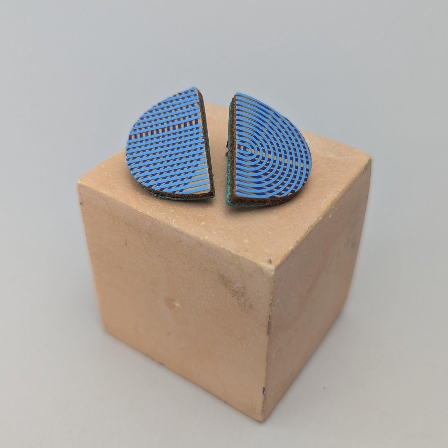 PATTERNED SEMI CIRCLE STUDS.